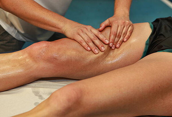 hands massaging athlete's thigh after running